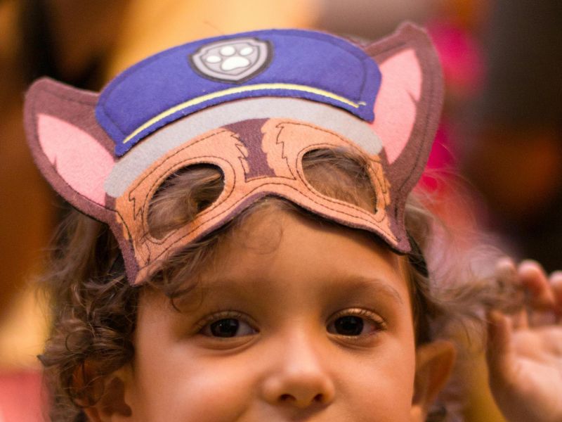 a kid wearing a cartoonish mask topeng muka 