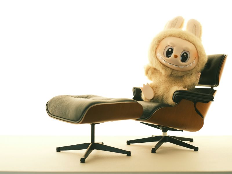 A labubu doll on a chair