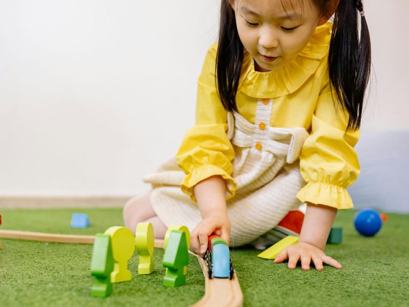 a little girl playing with some toys