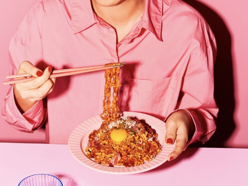 a person eating noodles samyang ramen